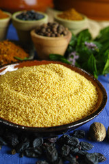 Organic yellow couscous and different spices in traditional eastern style