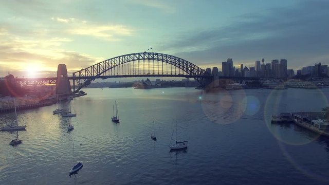 4k aerial footage b-roll of Sydney Harbour Bridge during sunrise. Cinematic look and lens flare effect.