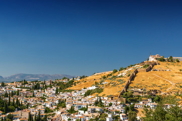Obraz premium Sunny view of Granada from viewpoint of garden of Generalife, Andalusia province, Spain.