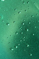 blue brushed metal surface with water drops