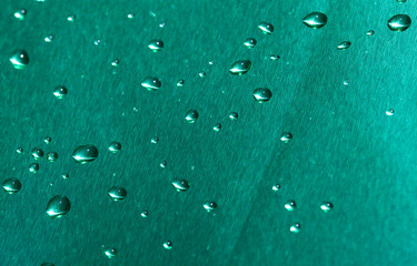 blue brushed metal surface with water drops