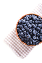 Bowl of ripe blueberries isolated on white