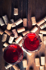 Two glasses of red wine and corks. Copyspace. Top view