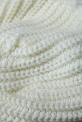 A full page of knitted white sweater fabric background texture
