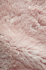 A full page of fluffy pink dyed sheepskin background texture