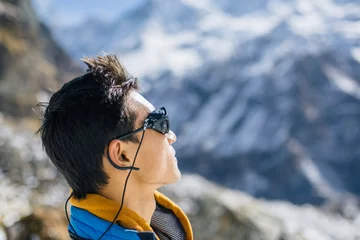 Rolgordijnen Profile portrait of young Sherpa wearing protective sunglasses in Himalayas © yossarian6