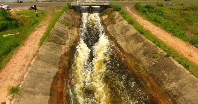 aerial drone shot ,  river water falls from the small dam