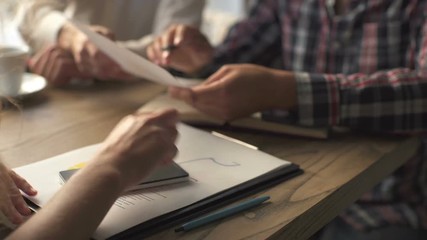 Two colleagues discussing data working and tablet, laptop with on on architectural project at construction site at desk in office - Powered by Adobe