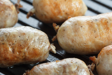 Chicken and beef sausages in a grill pan