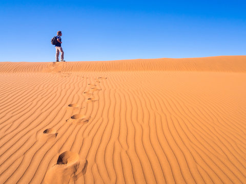 Single man walking on the Namib Desert