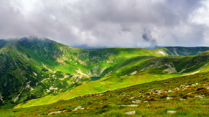 Obraz premium Picturesque and dramatic Carpathian mountains under huge rain clouds, nature landscape in summer, Ukraine.