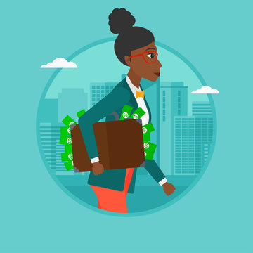 Business woman carrying briefcase full of money.