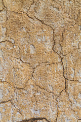 Cracked light beige coloured background texture