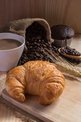 breaksfast and cup of coffee with coffee beans background.