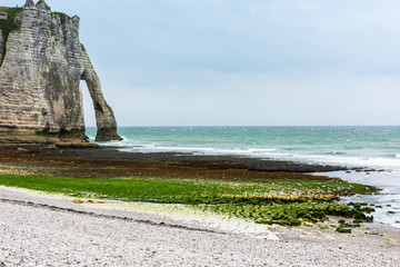 Obraz premium The beach and stone cliffs in Etretat, France