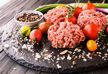 raw minced meat, vegetables with salt and spices, selective focus