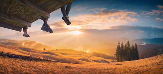 Hikers sit above the mountain valley