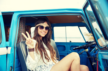 Fototapeta na wymiar happy hippie woman showing peace in minivan car