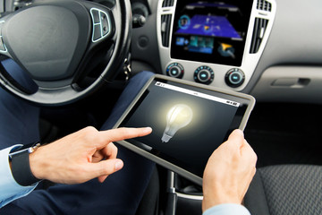 close up of man with tablet pc in car