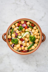 Chickpea salad on white marble background


