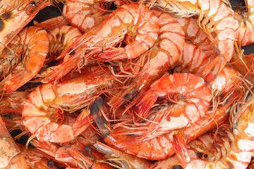 Grilled shrimp background, many fresh bbq shrimps together