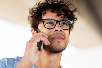 man with smartphone calling on city street