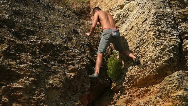 Climber Man Climbing Without Insurance On A Cliff