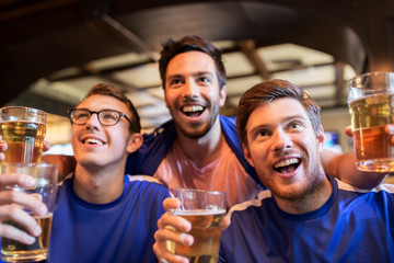 football fans or friends with beer at sport bar
