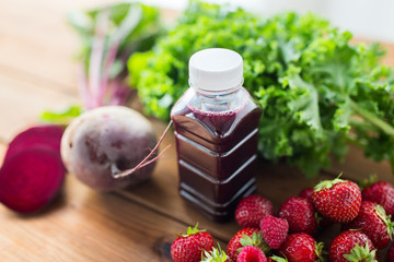 bottle with beetroot juice, fruits and vegetables