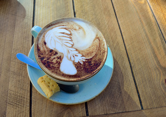 Cup of Cappuccino on wooden table