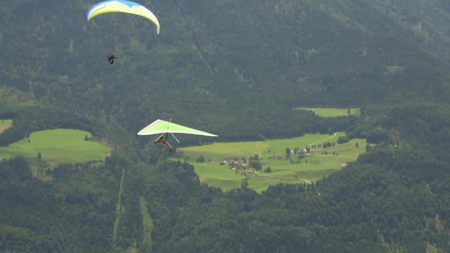 Green hang glider and green paraglider