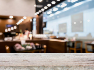 Wood table top on blur cafe restaurant with bokeh background