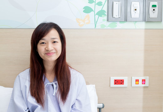 beautiful asian patient smiling in bed