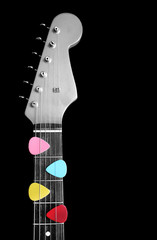 colorful picks on electric guitar, B&W processed on guitar. isolated on black
