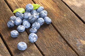  Blueberry and leaf on old wooden table.Close up and top view.