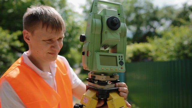 Surveyor at work measuring the distance