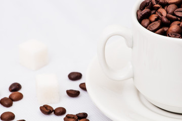 Coffee beans with white cup of coffee