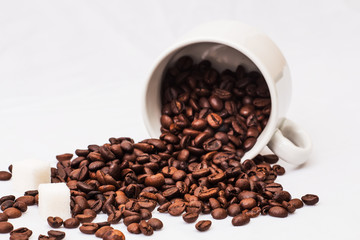 Coffee beans with white cup of coffee