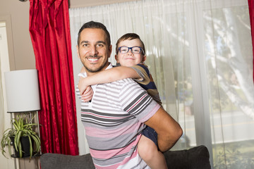 Father and son having fun at home in living room