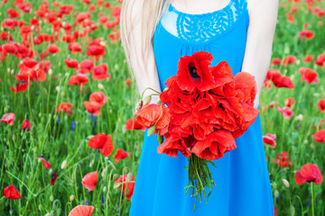 woman holding a bouquet of field poppy