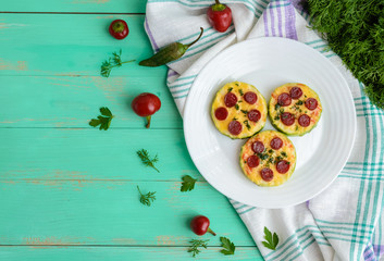 Small zucchini pizza on the circles with pepperoni and mozzarella. The top view