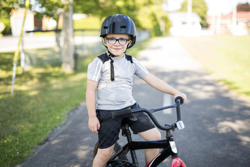 six year old boy biking in the park © Louis-Paul Photo