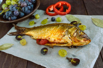 Baked fish carp, stuffed bell peppers and grapes.
