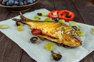 Baked fish carp, stuffed bell peppers and grapes.