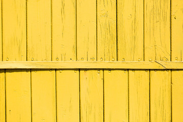 wooden fence with yellow paint