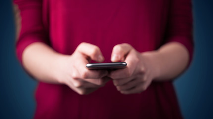 Young woman holding smarthphone in hand