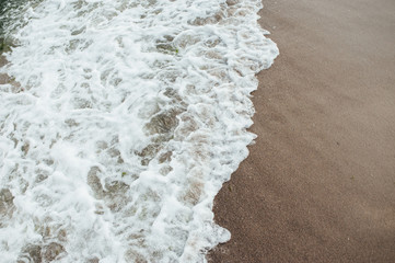 Soft wave of the sea on the sandy beach