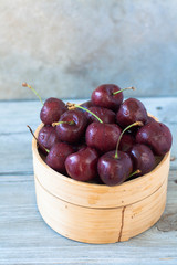 Sweet ripe cherries in a bamboo basket 