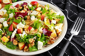 Light Fresh Home made fruit apple salad with walnuts, vegetables, feta cheese