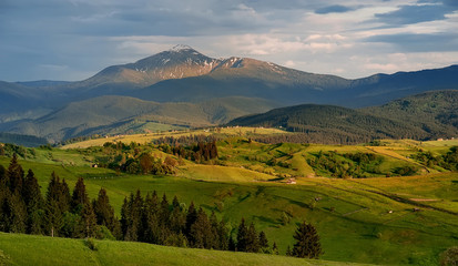 beautiful rural landscape with mountain view on horizon  and blue cloudy sky